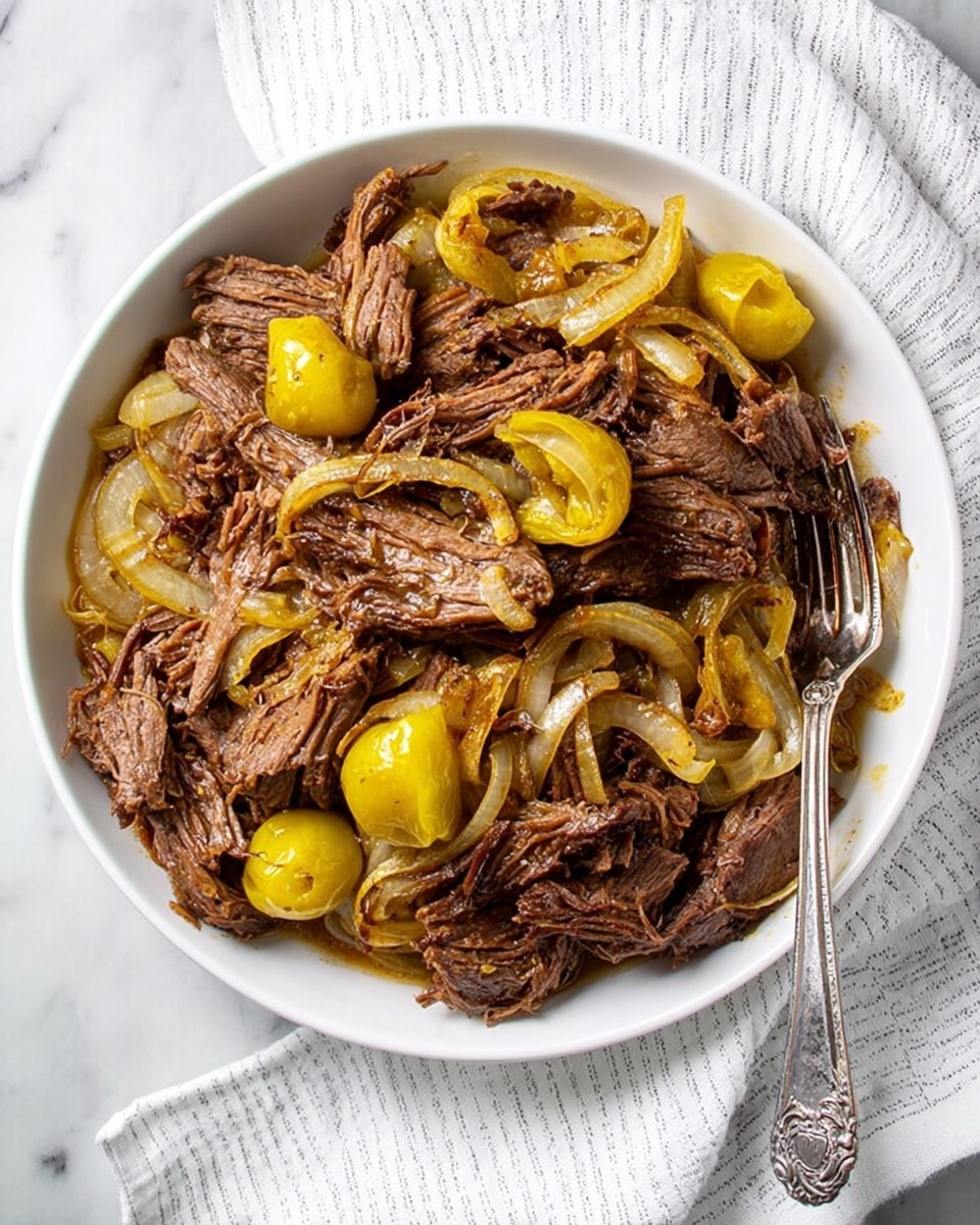 A white round bowl filled with shredded dark brown slow-cooked beef mixed with light yellow sliced onions and whole yellow pepperoncini peppers, all covered in a light sauce that glistens on the meat and vegetables. The beef has a fibrous texture showing the shredding, with some pieces slightly crispy on edges. The onions are soft and translucent, layered throughout the beef. A silver ornate fork rests inside the bowl on the right side, partially submerged in the dish. The bowl is placed on a white marbled surface, next to a white cloth with thin light grey stripes. photo taken with an iphone --ar 4:5 --v 7