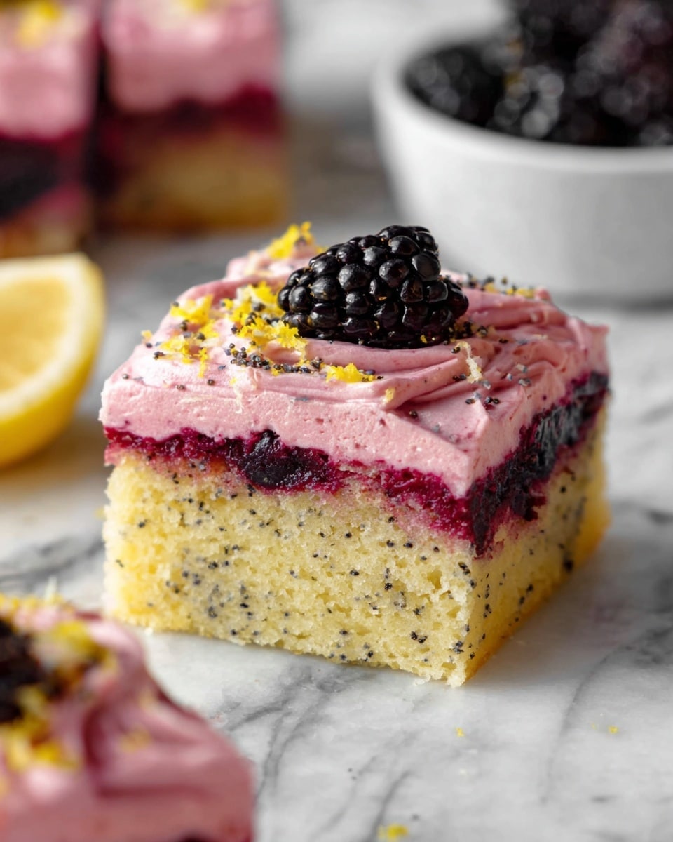 A square piece of cake with two visible layers is shown on a white marbled surface. The bottom layer is a light yellow sponge with small black poppy seeds scattered inside and a darker patch indicating blackberries baked into the cake. On top, there is a thick, swirled layer of pink frosting sprinkled with tiny yellow zest and small black poppy seeds. A fresh blackberry sits on one corner of the frosting, and there is a drizzle of darker red syrup on top. Other pieces of the cake and a white bowl filled with blackberries are seen blurred in the background. Photo taken with an iphone --ar 4:5 --v 7