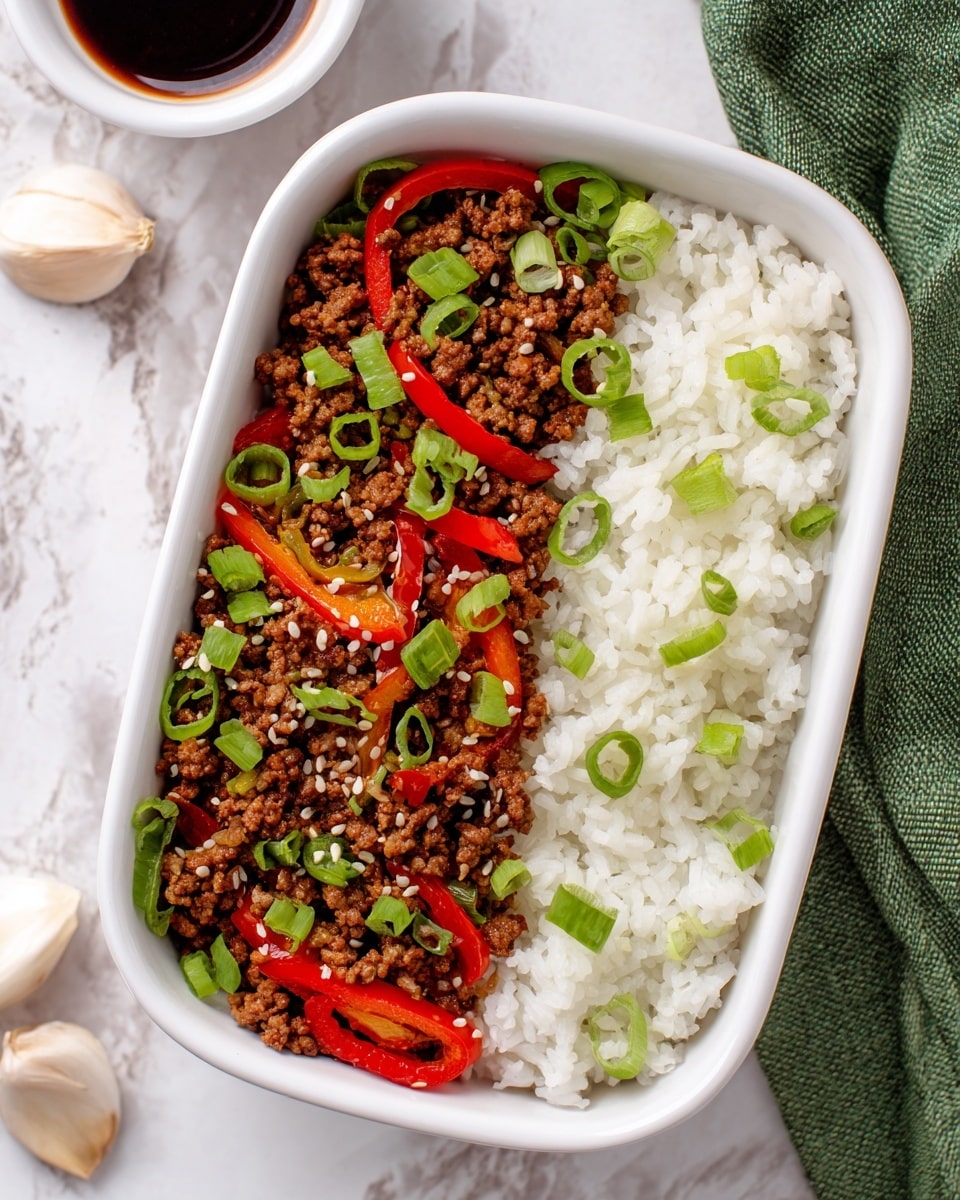 A rectangular yellow container with two main layers inside: one side filled with white steamed rice topped with small green onion slices, and the other side with ground beef cooked with bright red bell pepper strips, garnished with green onion slices and sprinkled with sesame seeds. The container is placed on a green cloth on a white marbled surface, with a small white bowl of dark soy sauce mixed with small garlic and chili pieces in the background. photo taken with an iphone --ar 4:5 --v 7