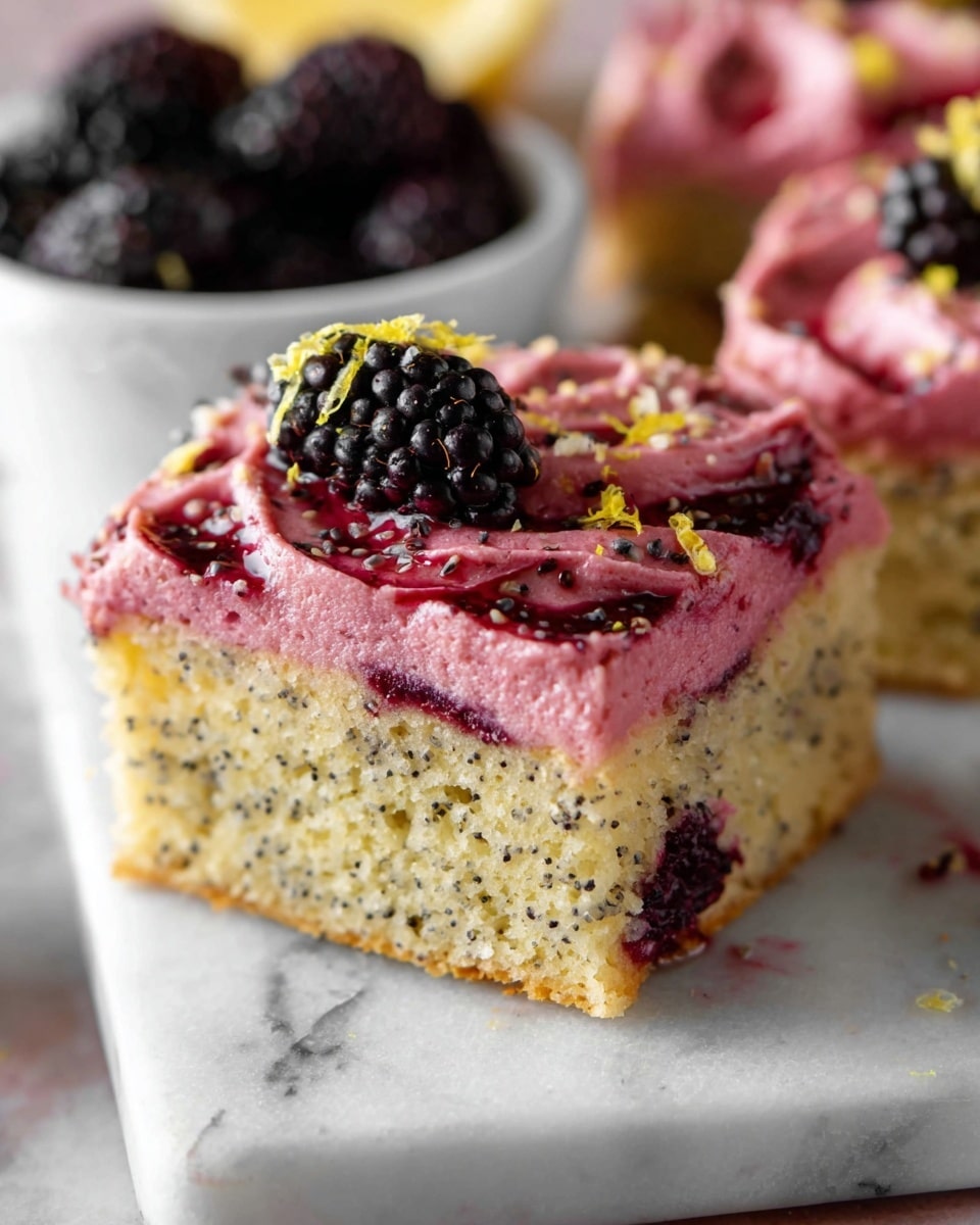 A square piece of cake with two visible layers is shown. The bottom layer is light yellow with small dark specks and a soft, moist texture, dotted with blackberries inside. The top layer is a smooth pink frosting, thickly spread with swirls, decorated with a whole blackberry, dark red berry sauce, and small yellow zest pieces, sprinkled lightly with tiny black seeds. The cake sits on a white marbled surface with part of a white bowl filled with blackberries visible in the background. Photo taken with an iphone --ar 4:5 --v 7