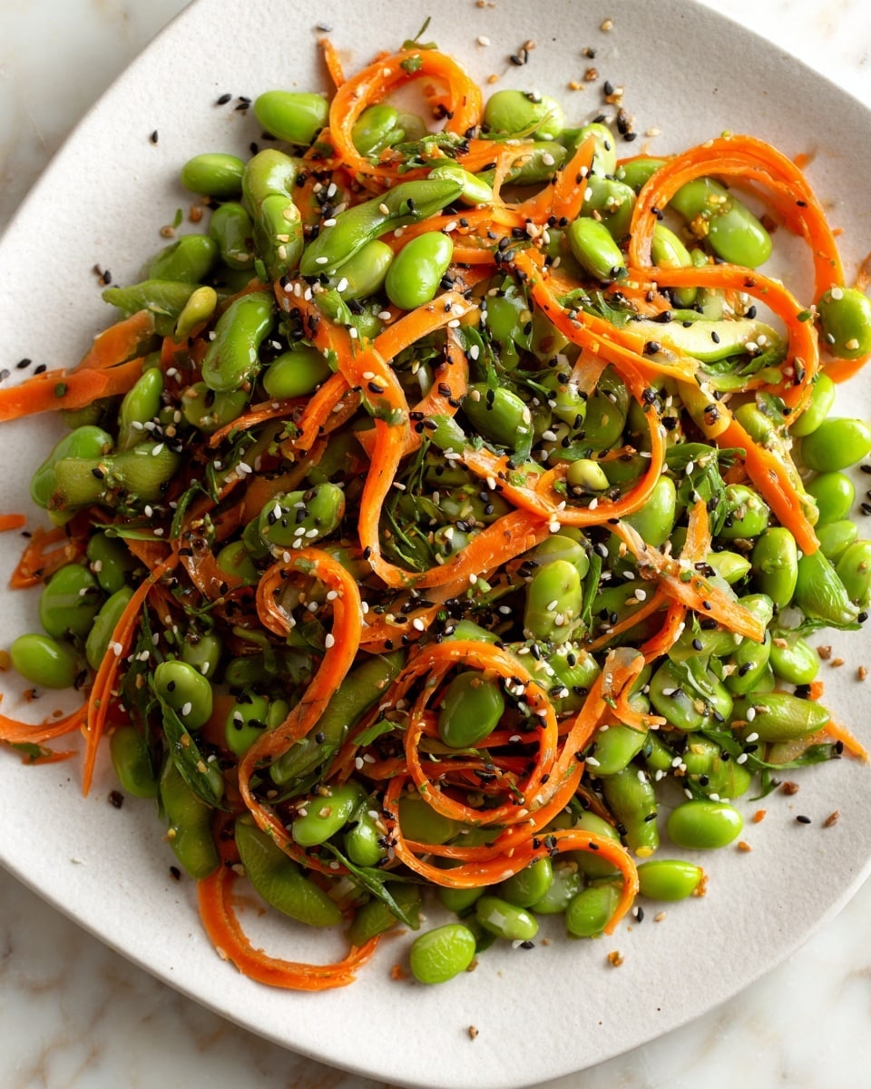 The dish is a colorful mix of bright green edamame beans and thin orange carrot strips placed on a white square plate. The edamame is fresh and plump, while the carrots add a crunchy texture, scattered evenly throughout. Small black and white sesame seeds are sprinkled across the top, adding texture and a touch of contrast to the fresh vegetables. The plate sits on a white marbled surface, enhancing the fresh and healthy feel of the dish. photo taken with an iphone --ar 4:5 --v 7