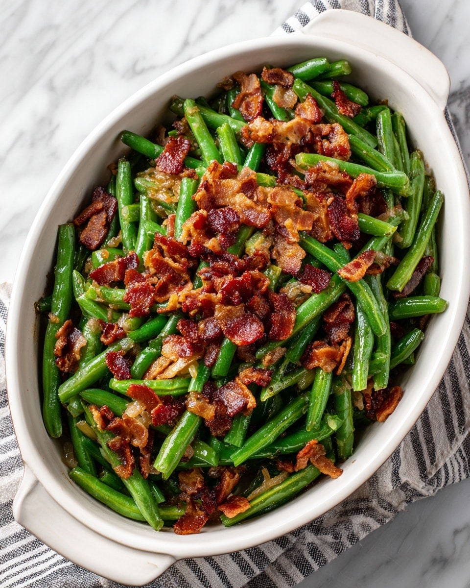 The dish is a white oval casserole filled with cooked green beans and topped with crispy pieces of reddish-brown bacon. The green beans are whole and have a glossy texture, showing they are well cooked but still firm. The bacon pieces are scattered evenly on top, with a crunchy texture and a mix of darker red and lighter brown colors. The white casserole contrasts with the vibrant green and reddish tones of the food, and the dish is placed on a white marbled surface. Photo taken with an iphone --ar 4:5 --v 7