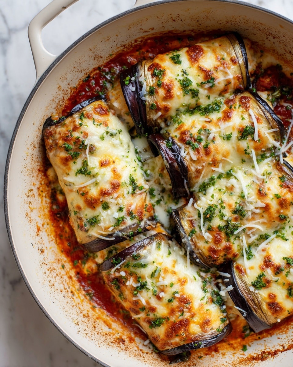 The image shows five baked eggplant rolls in a white ceramic pan on a white marbled surface. Each roll is covered with a golden-brown melted cheese layer that has some darker browned spots. The rolls have a visible green herb sauce drizzled on top, with small pieces of fresh herbs scattered over the cheese. Along the edges, red sauce peeks out beneath the cheese and eggplant skin, adding a splash of color. The eggplant skin is dark purple and forms the outer layer, holding the filling inside. Photo taken with an iphone --ar 4:5 --v 7